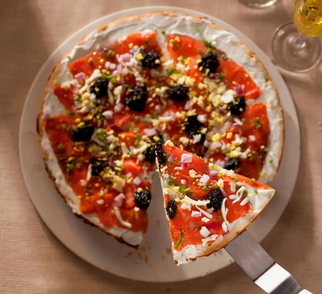 A pizza with caviar on top