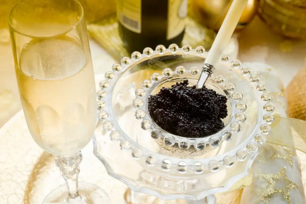 Served black caviar with a glass of champagne