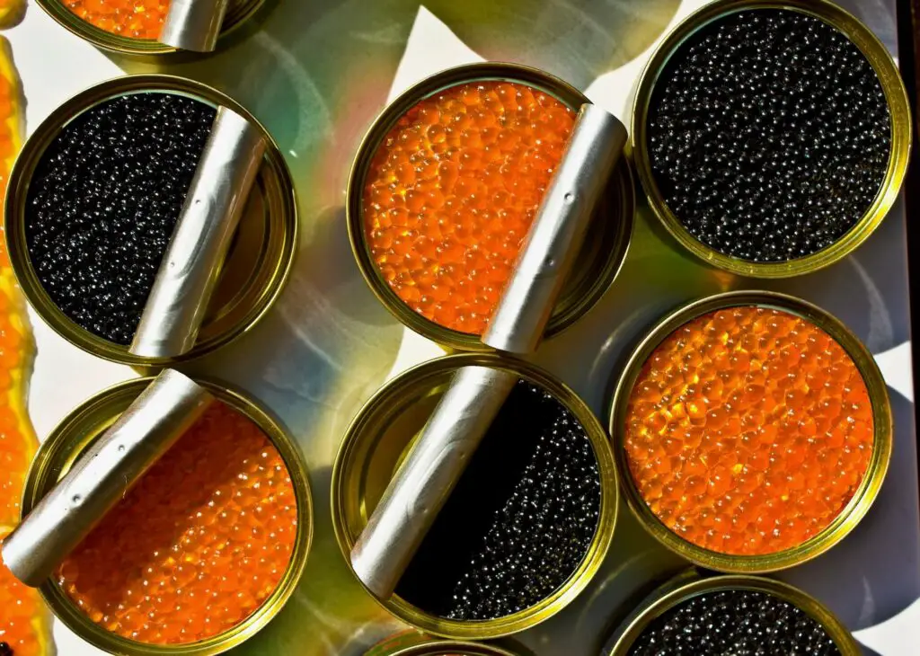 Tin cans of different-colored caviar