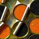 Cans of caviar on the table