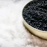A tin of black caviar in ice